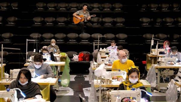 Volunteers sew face masks as a guitarist plays for them at the Hafez theater hall in downtown Tehran, Iran. -- Courtesy photo
