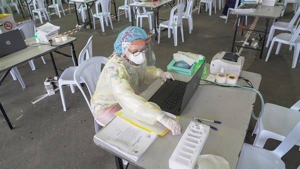 A doctor prepares her station ahead of the arrival of a planeload of repatriated Kuwaiti citizens at a makeshift field testing center at Kuwait Airport. -- Courtesy photo