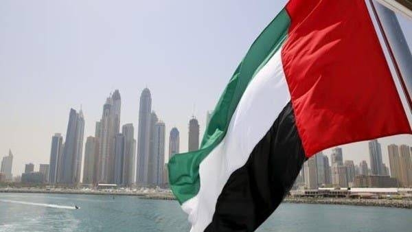 UAE flag flies over a boat at Dubai Marina. -- File photo
