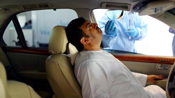 A member of medical staff wearing protective gloves takes a swab from a man during drive-thru coronavirus disease testing (COVID-19) at a screening center in Abu Dhabi. -- Courtesy photo