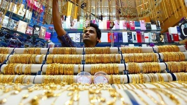 A salesman arranges jewelry at a shop at the gold souk in Deira, Dubai. -- File photo
