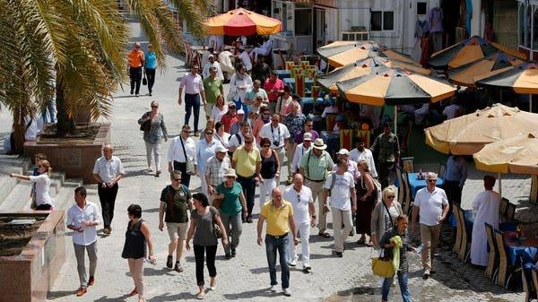 People walk on a street in the Omani capital, Muscat. -- File photo
