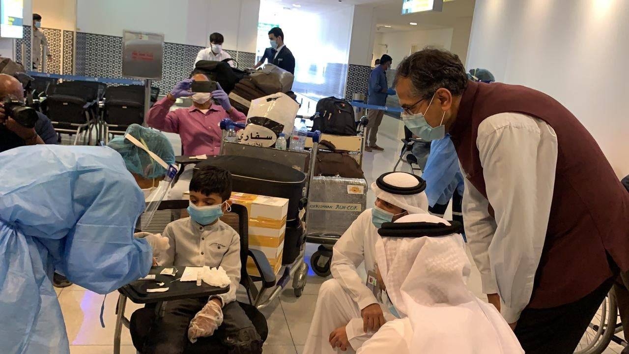 Indian Ambassador to UAE Pavan Kapoor is seen with some of the passengers undergoing medical screening at Abu Dhabi airport before they board the Abu Dhabi-Kochi repatriation flight, on Thursday. — Courtesy photo