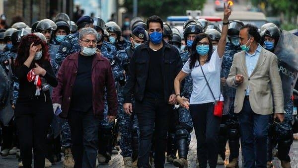 Lebanese demonstrators wear face masks during a protest against the collapsing Lebanese pound currency in Beirut. -- Courtesy photo
