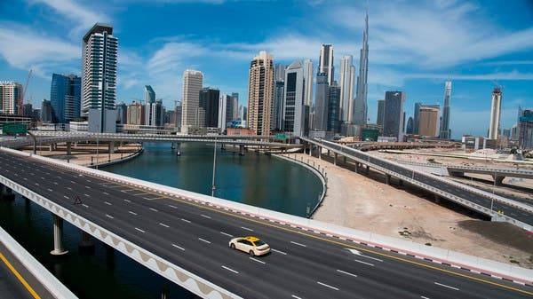 A lone taxi cab drives over a typically busy road in Dubai during coronavirus lockdown. -- File photo
