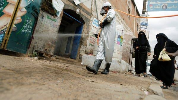 A health worker wearing a protective suit disinfects a market amid concerns of the spread of the coronavirus in Sanaa, Yemen. -- File photo
