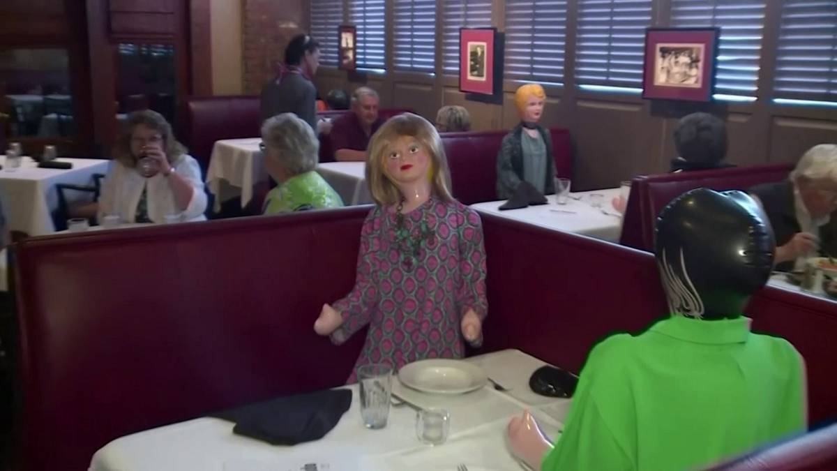 A screengrab of a video shows a restaurant in South Carolina uses blow up dolls to maintain social distancing measures.