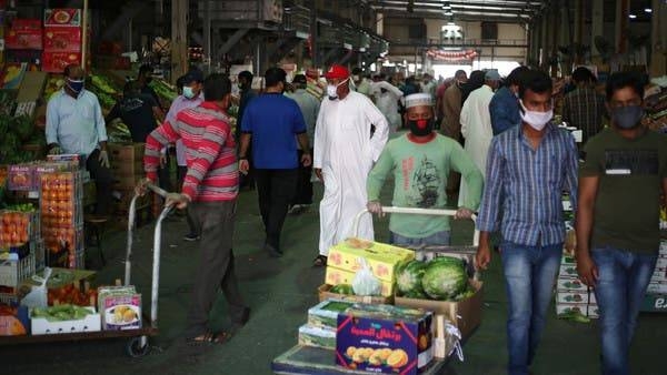 People wear protective face masks following the outbreak of the coronavirus, as they shop at a vegetable market in Manama. -- Courtesy photo
