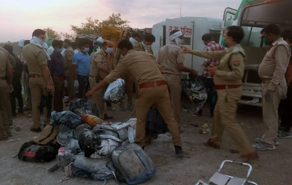 Police inspect the accident site where 24 migrant workers were killed and 37 injured early Saturday on a highway in northern India.