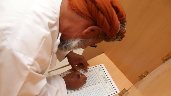 An Omani man fills out his ballot for the municipal elections, at a polling station in Al-Suwayq, in northeastern Oman in this file photo
