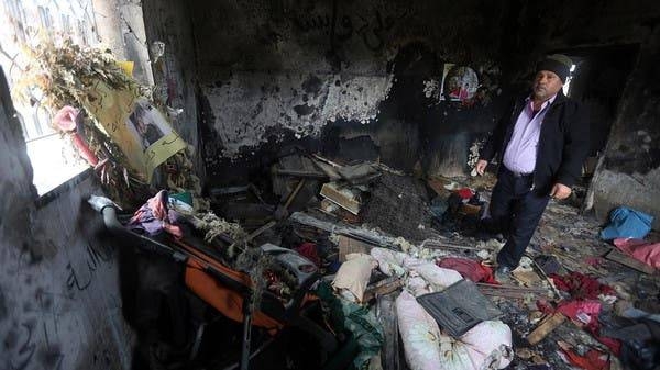 
A relative stands inside the burnt-out home of Saad Dawabsha, who was killed alongside his toddler and his wife when their house was firebombed by settlers. -- File photo
