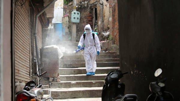 An Indian municipal worker disinfects an area during lockdown to prevent the spread of coronavirus in Jammu, India. -- File photo
