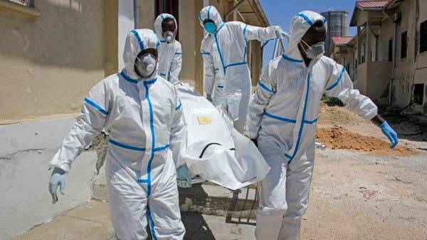 Medical workers in protective suits carry the body of a man who died of COVID-19, before he is buried in Mogadishu, last week. -- Courtesy photos
