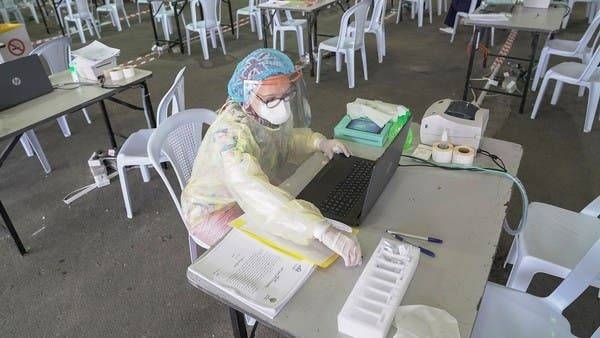 A Kuwaiti doctor prepares her station ahead of the arrival of a planeload of repatriated Kuwaiti citizens at a makeshift field testing center. -- File photo  
