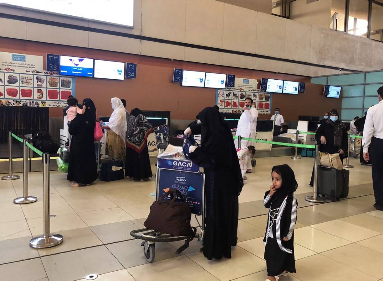 Passengers completing their procedures prior to departure from Jeddah in PIA flight to Faisaabad.