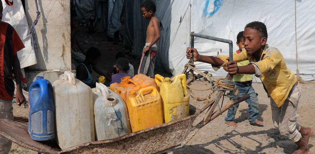 A 13-year-old boy collects water in Ammar Bin Yasser, a camp for people displaced by the conflict in Yemen. — courtesy UNICEF