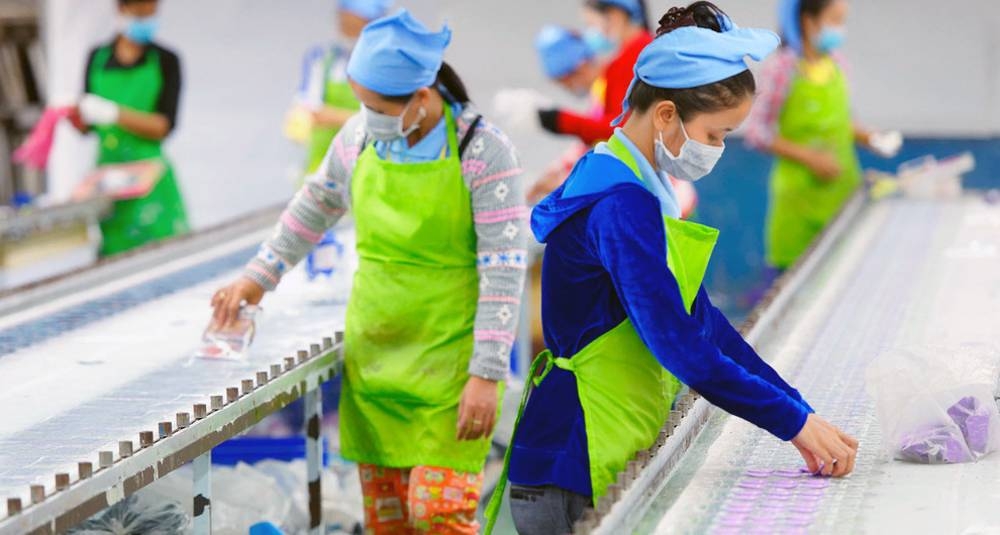 Factory workers in an assembly line in Cambodia. — curtesy ILO/Marcel Crozet