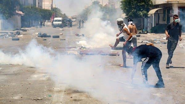 Protesters from Tunisia's Tataouine region throw stones as they clash with security forces in the southern city, Sunday. — Courtesy photo
