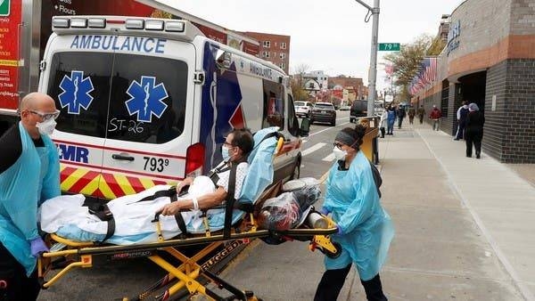 Medics move a patient outside of Elmhurst Hospital in New York. – File photo
