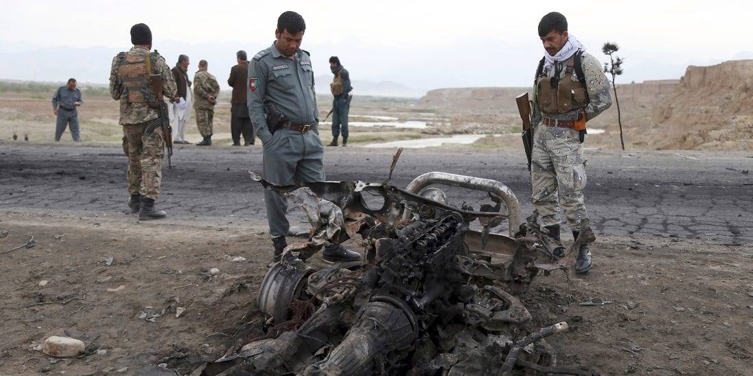 Afghan security forces gather at the site of a suicide attack near the Bagram Air Base, north of Kabul, in this file photo.
