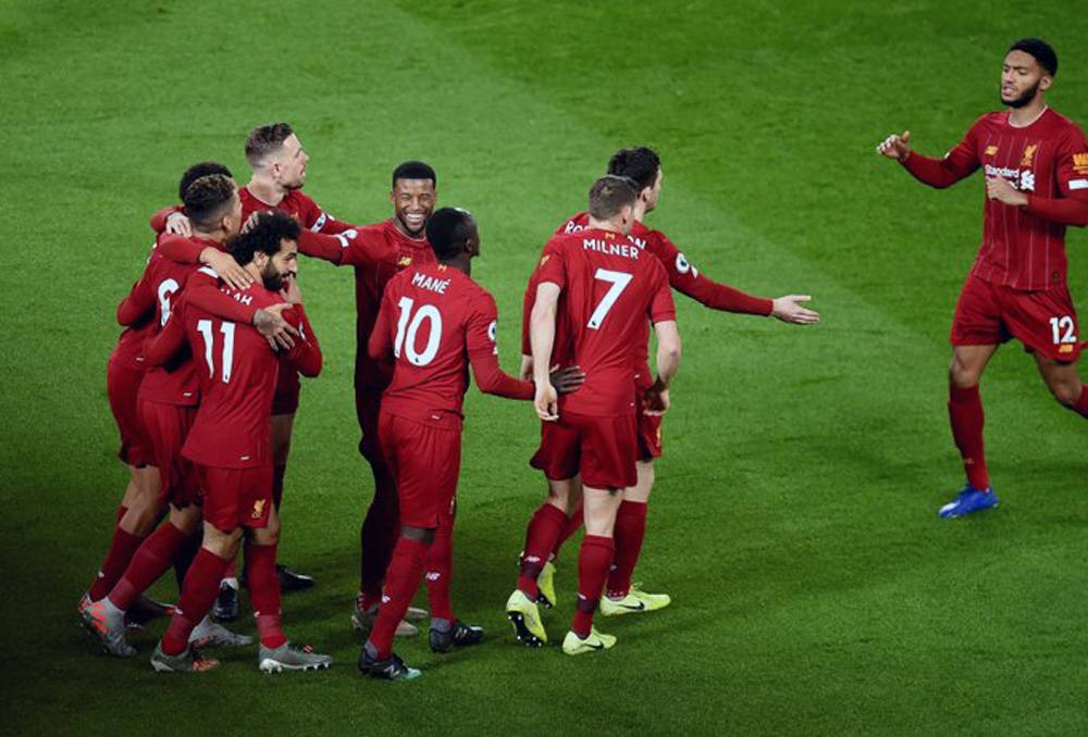 Liverpool players celebrate after being crowned Premier League champions, winning their first title in 30 years.