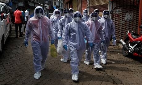 Healthcare workers wearing personal protective equipment (PPE) walk toward different localities before the start of a check-up camp for the coronavirus disease (COVID-19) in Mumbai, India. — Courtesy photo