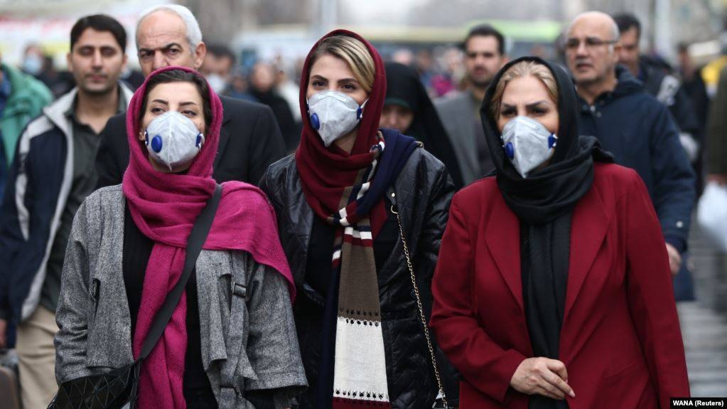 Iranians walk along a street near the artificial Chitgar lake in the capital Tehran. — Courtesy photo
