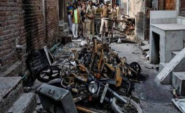 Police photograph burnt properties owned by Muslims in a riot-affected area in Delhi on March 2. — Courtesy photo
