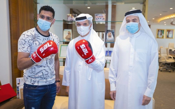 Two-time world champion Amir Khan with Saeed Hareb, secretary general of DSC, and Nasser Aman Al Rahma, assistant secretary general of DSC.