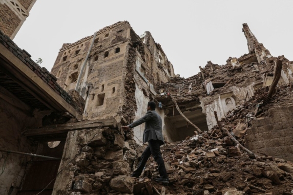 A man walks past a building collapsed by rain in the UNESCO World Heritage site of the old city of Sanaa.