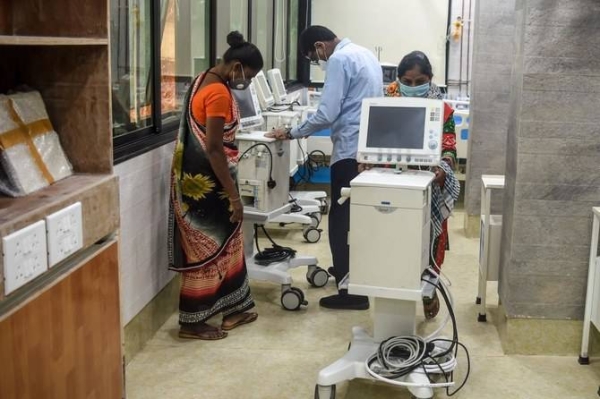 Workers arrange machines at a hospital recently set up for COVID-19 coronavirus patients in Mumbai. — File photo
