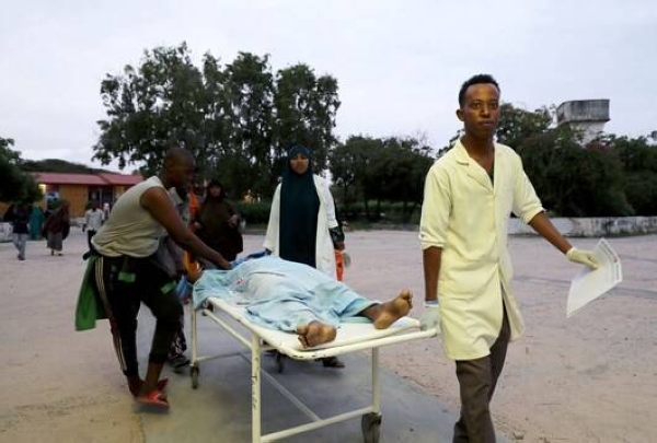 Paramedics and civilians carry an injured person on a stretcher at Madina Hospital after a blast at the Elite Hotel in Lido beach in Mogadishu, Sunday. — Courtesy photo