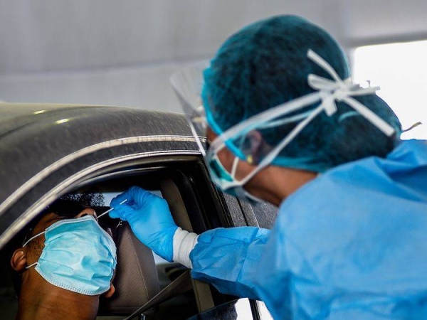 A paramedic staff collects swab samples at a coronavirus drive-through screening center located at Sharjah Golf and Shooters Club. — Courtesy photo