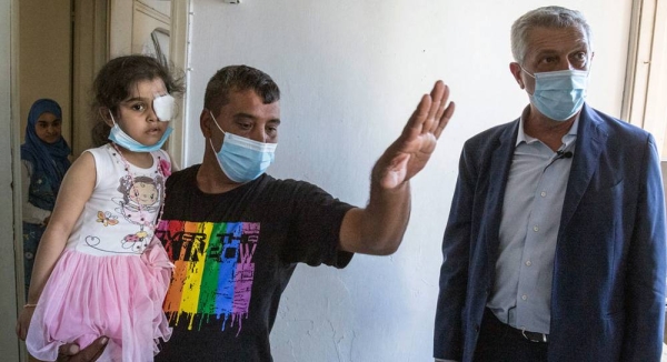 The UN refugee chief Filippo Grandi looks at damage caused to the apartment of a Syrian refugee in the aftermath of the explosion at the port in Beirut, Lebanon. – courtesy UNHCR/Sam Tarling