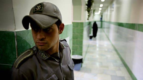 A prison guard stands along a corridor in Tehran's Evin prison in this file photo.
