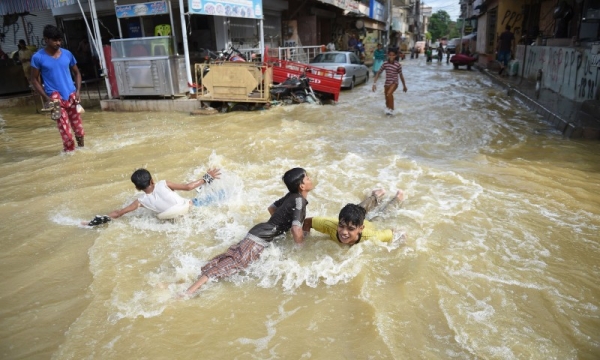 Pakistani children play in a flooded street after heavy rain in Karachi in this Aug. 31, 2017 file photo. — AFP