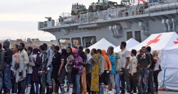 Migrants queue after disembarking from the Royal Navy ship HMS Bulwark upon their arrival in the port of Catania on the coast of Sicily. — File photo
