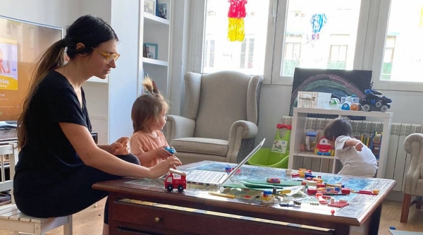 On the afternoon of Friday, April 3, 2020, in Madrid, Spain, Ruben, 4, and his little sister play while their mother, Daniela, gets in a little work. — courtesy UNICEF/Sergio Robles