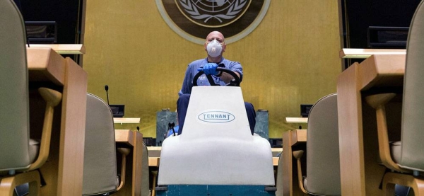 A cleaning crew member operates a mopping vehicle inside the General Assembly Hall. — courtesy UN Photo/Manuel Elias