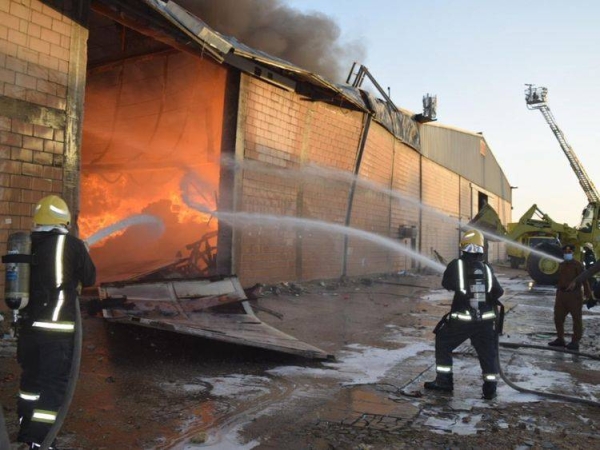 Firefighters battling a blaze in a warehouse in Riyadh. — Civil Defense photo
