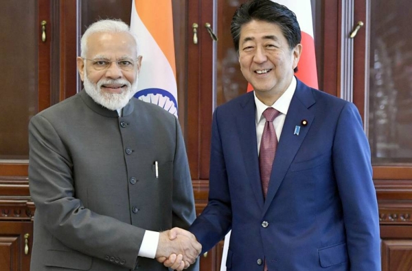 Japanese Prime Minister Shinzo Abe (R) and his Indian counterpart Narendra Modi shake hands before talks in Vladivostok, Russia, on Sept. 5, 2019. — courtesy Kyodo