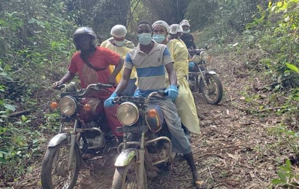 Marie-Roseline Darnycka Bélizaire, an epidemiologist with the World Health Organization, rides through the forest near Itipo on the way to a follow-up visit with a contact. — courtesy WHO/Lindsay Mackenzie