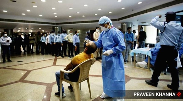 A team of health workers takes swab samples for COVID-19 test of Civic Center staff in New Delhi on Tuesday. — Courtesy photo
