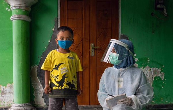 A child is weighed at a community health center in Central Java province, Indonesia. — courtesy UNICEF/UNI350093/Ijazah