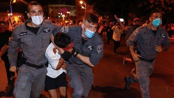 Israeli security officers detain a protester during an anti-government demonstration in front of Prime Minister Benjamin Netanyahu's residence in occupied Jerusalem, Sunday evening. — Courtesy photo