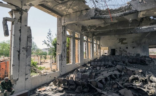 A military guard sits in the former Assembly Hall of the Governor of Saada. Since the Yemen conflict escalated in 2015, much of the city's infrastructure has been destroyed (file photo). – courtesy Giles Clarke/UN OCHA