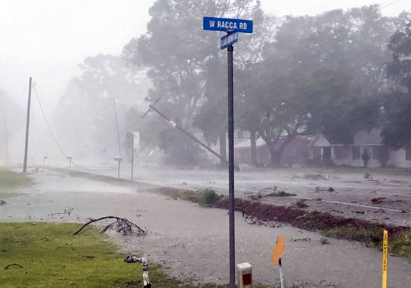 The road south of Jennings blocked by power poles and deep water both sides of HWY 26. — courtesy Twitter