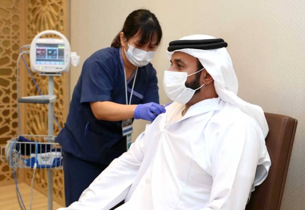 Director-General of the National Emergency Crisis and Disasters Management Authority, (NCEMA) Obaid Rashid Al Shamsi getting the first dose of COVID-19 vaccine.