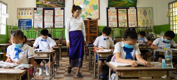 Teachers and students wear face masks and maintain physical distance at a school in Cambodia. — Courtesy photo