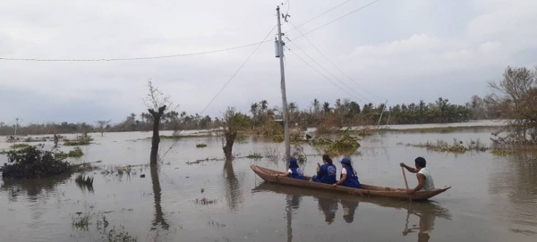 An IOM team on the ground in Camarines Sur, one of the regions badly hit by Typhoon Goni, locally known as Rolly. With transport links damaged, the team uses a boat to reach the affected areas.— Courtesy photo